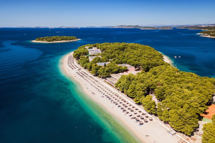 Eine Luftaufnahme einer Sandbank, die ins türkisfarbene Meer ragt.