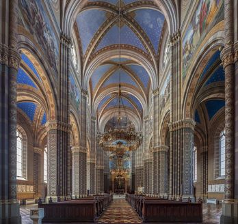 Ein Innenraum einer Kathedrale mit hohen Bögen und Säulen.