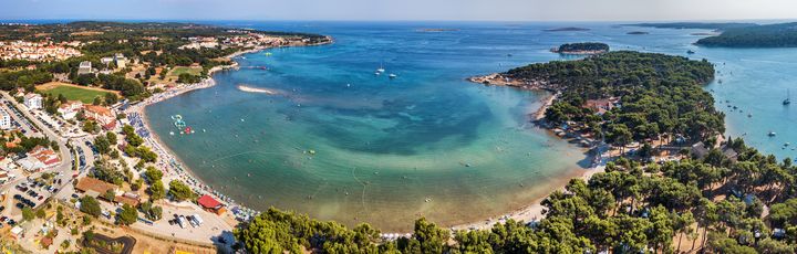 Eine Luftaufnahme einer Bucht mit türkisfarbenem Wasser.