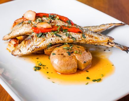 Eine Platte mit gegrilltem Fisch und Gemüse.