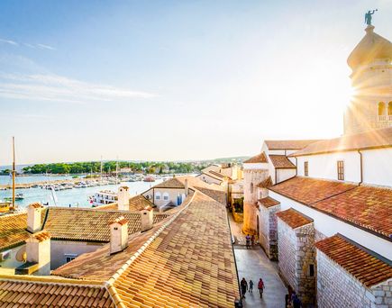 Eine Terrasse mit Blick auf eine Stadt und das Meer.