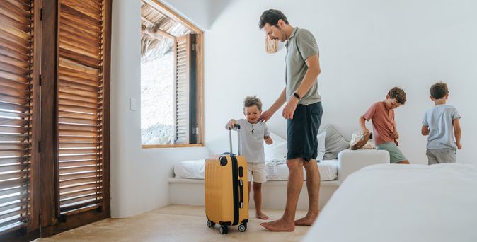 Familie in der Ferienwohnung mit gelbm Koffer