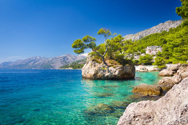 Eine felsige Bucht mit türkisblauem Wasser.