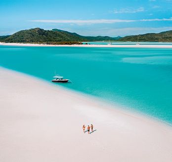 Türkises Meer und Traumstrand mit Menschen und Boot