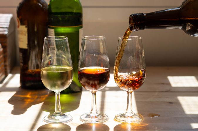 Ein Tisch mit Gläsern Wein und Speisen im Freien.