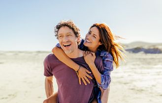 Pärchen Huckepack am Strand