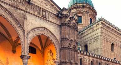 Ein historisches Gebäude mit einem Torbogen und einer Kathedrale.