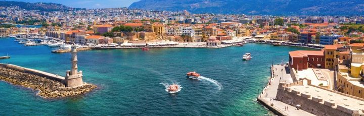Eine Luftaufnahme einer Küstenstadt mit einem Hafen und Bergen.