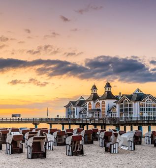 Blick über den Strand mit Strandkörben auf die Seebrücke in Sellin auf Rügen