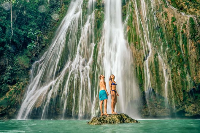 Paar steht unterkaribischem Wasserfall