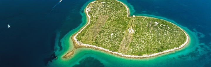 Eine herzförmige Insel mit türkisfarbenem Wasser.