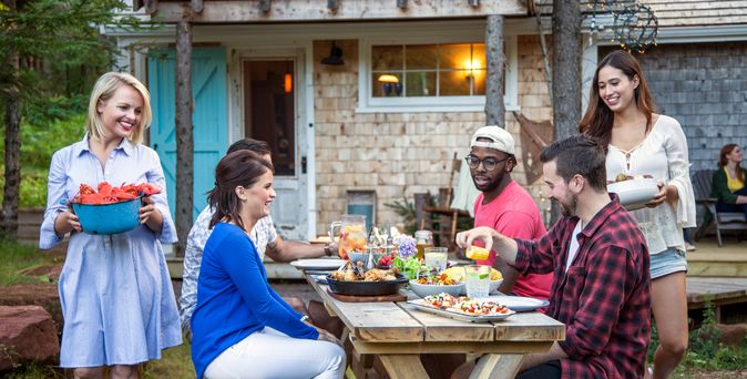 Gruppe von Menschen beim Essen im Garten