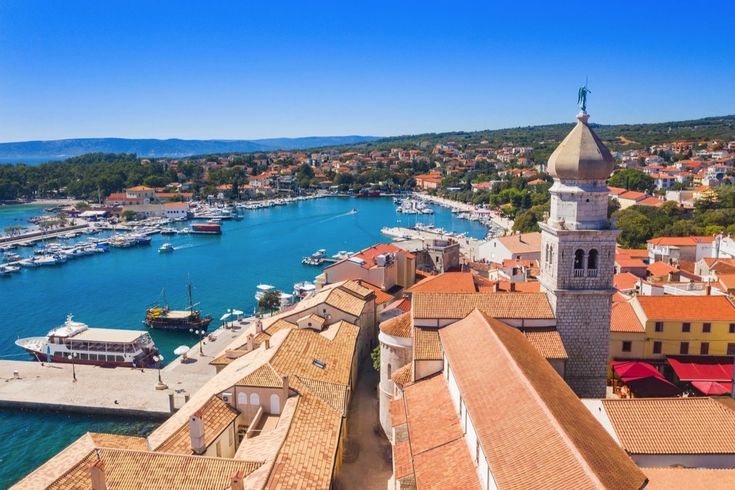 Die Altstadt von Krk, Kroatien, mit roten Dächern und einem Kirchturm.