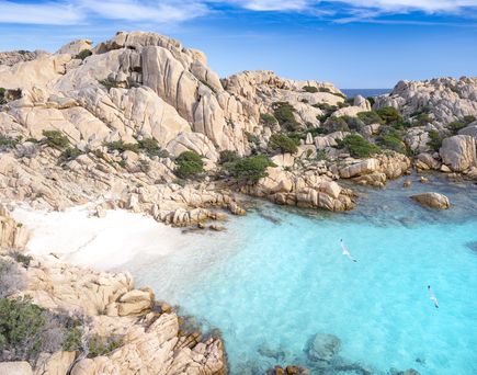 Sandbucht mit Felsen, hellblauem Meer und weißem Sandstrand auf der Insel Sardinien in Italien 