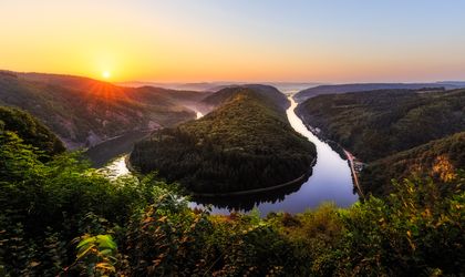 Panoramablick auf die Saarschleife im Saarland bei Sonnenuntergang, mit Nebel im Tal.