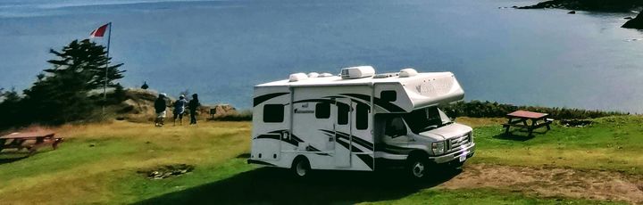 Camper in Nova Scotia auf der Klippe mit Meer im Hintergrund