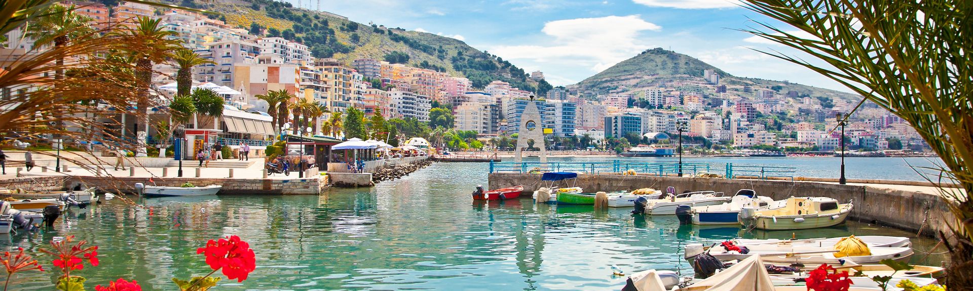 Blick auf den HAfen in Albanien mit Palmen am Bildrand
