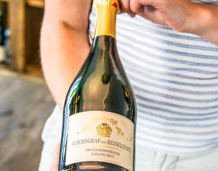 Eine Flasche Wein wird in ein Glas eingeschenkt.