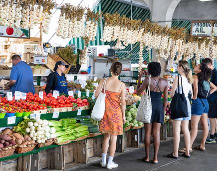 Personen auf einem Markt mit verschiedenem Gemüse in Montreal