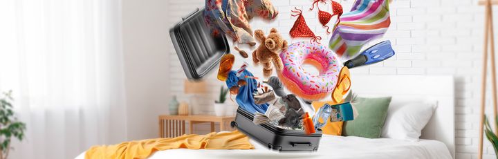 Motiv Reiserücktrittskostenversicherung ADAC Bett auf dem ein Koffer Steht aus dem Kleidungsstücke fliegen