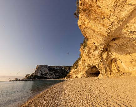 Eine felsige Bucht mit einem Sandstrand.