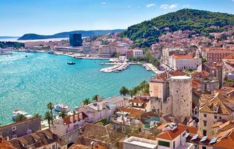 Eine Luftaufnahme einer Küstenstadt mit einer Insel und dem Meer.