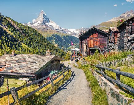 Eine Berglandschaft mit traditionellen Holzhäusern in Zermatt.