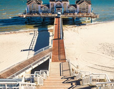 Ein hölzerner Steg führt zum Strand.